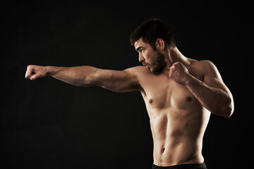 Man, fitness and boxer with fist in training, workout or studio exercise on a black background....