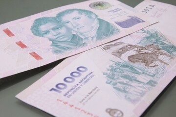 Argentine Money - Currency of Argentine, Pesos argentinos. Ten thousand pesos bill, ten thousand pesos cash bills on dark background.