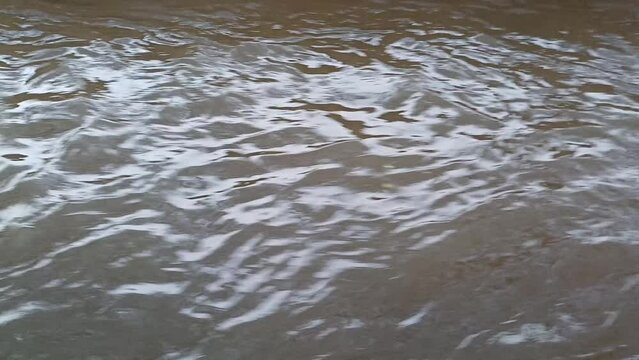 water flow in the river with small waves created, water background