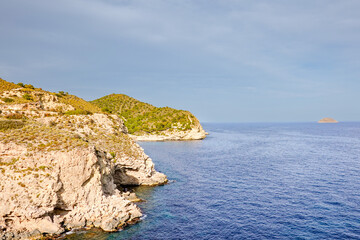 View to Mediterranean Sea with Benidorm island and rocky cliffs from hiking cliff path near...