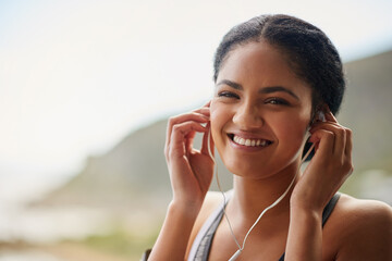 Woman, portrait or smile with headphones in nature for exercise, listening or streaming for...