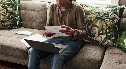 Paperwork, laptop and man sitting on sofa in home for finance, accounting and debt in living room....