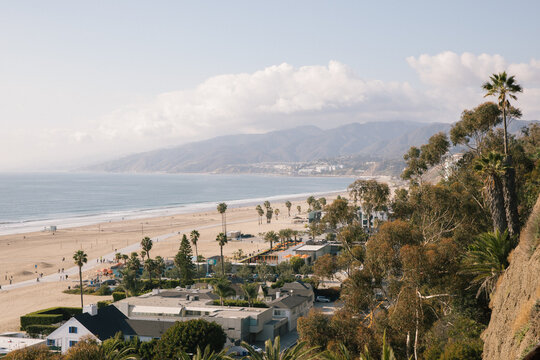 View of Santa Monica Beach coastline looking towards Malibu on a sunny day.