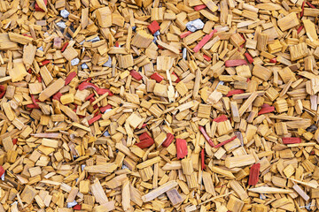 Finely chopped pieces of stained wood. Decorative element on a rock garden.