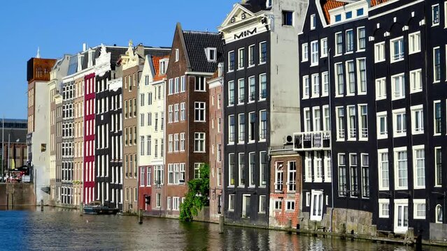 Waterfront Damrak Canal Houses in Amsterdam, The Netherlands.