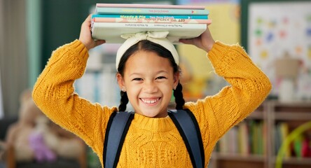 Child, face and books on head or excited for school learning or reading lesson, classroom or...