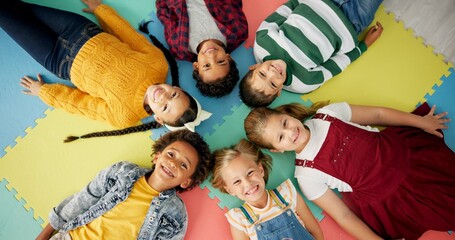 Children, relax and circle on mat in school with funny faces top view for relax, fun and classroom. Group, kids and happy on floor for education, learning and knowledge with game for bonding