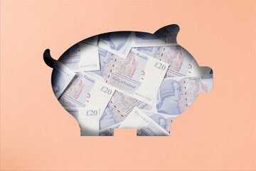 Twenty pound sterling banknotes heap under pink paper cutout piggy bank icon