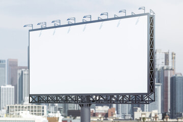 Blank white horizontal billboard on cityscape background at daytime, perspective view. Mockup, advertising concept