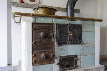 An old tiled kitchen oven for wood heating in a historic old farmhouse from 1728