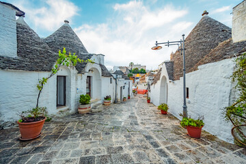 Trulli of Alberobello, Puglia, Italy. town of Alberobello with trulli houses among green plants and...
