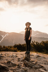 Obraz premium Young traveler hiking girl with backpacks. Hiking in mountains. Tourist traveler. Hiking in Slovakia mountains landscape. Low Tatras national park, Slovakia.