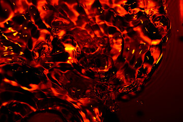 Metallic red water surface Soft waves and air bubbles in the water.