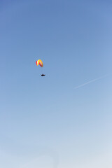 red and yellow Parachute flying above land