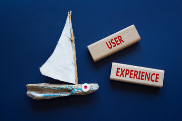 User Experience symbol. Concept word User Experience on wooden blocks. Beautiful deep blue...