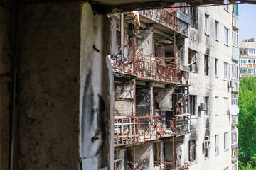 Closeup view of ruined facade of house.