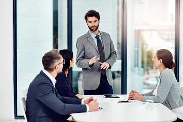 Talking, business and people in meeting office for feedback, review or planning of company growth. Corporate, man and staff for discussion in workshop with support of team for ideas on project