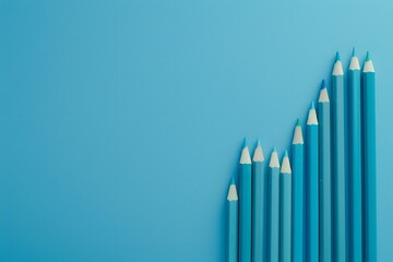 Obraz premium Light Blue Pencils on Blue Background Shaped as Upward Graph