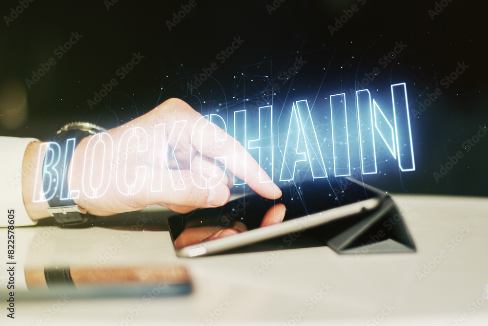Poster double exposure of blockchain technology hologram and finger clicks on a digital tablet on backgroun
