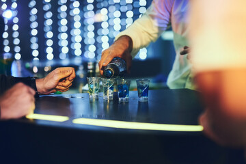 Barman, drinks and pour alcohol in night club for service, order and counter server with...