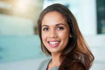Fototapeta premium Face, portrait and business woman with smile or proud for career, job and growth with opportunity. Female employee, happy and confident or satisfied as accountant for corporate company at office