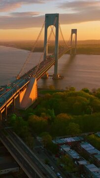 Highways leading to the big beautiful bridge. Stunning view of Bronx Whitestone bridge over magnificent river. Vertical video