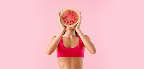 Young woman holding fresh watermelon on pink background