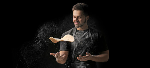 Man kneading dough in kitchen