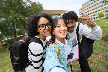 selfie of three young students at the campus