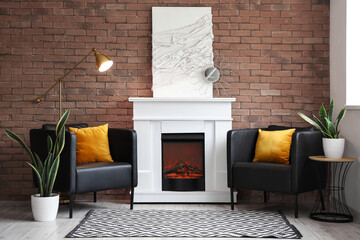 Stylish fireplace and armchairs near brick wall