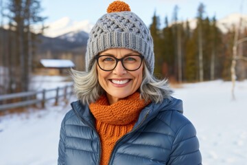 Portrait of an adult woman in the winter air, against the background of a ranch in the mountains in the forest, winter outdoor leisure
