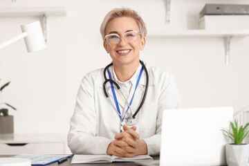 Mature female doctor at workplace in clinic