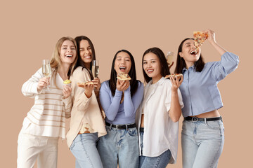 Group of young women with champagne and pizza on beige background. Hen Party