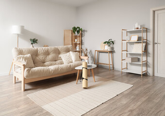 Interior of living room with sofa, yoga mat and laptop on table