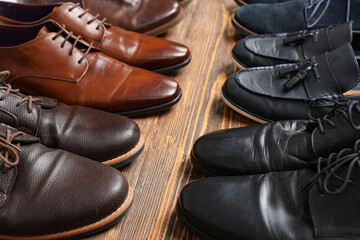 Different shoes on wooden background