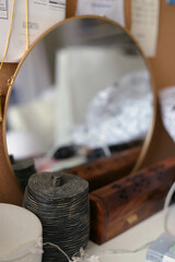 Round antique mirror and clutter on the table interior