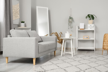 Light modern living room with cozy couch, coffee table and carpet