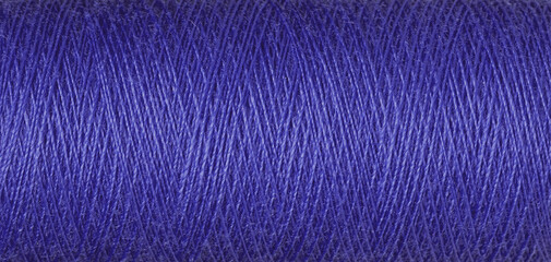macro texture of a skein of purple sewing thread