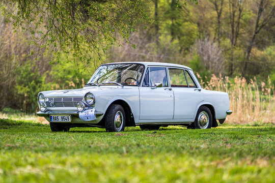 Historic French-made Simca 1300 car outside in nature on a meadow.