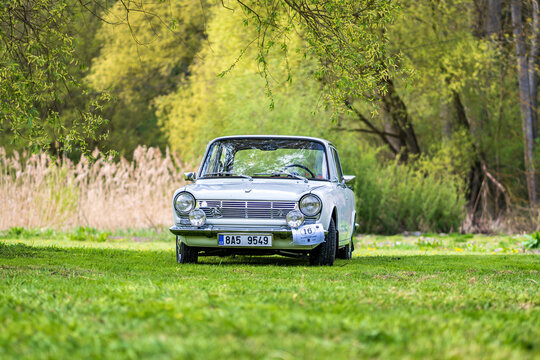 Historic French-made Simca 1300 car outside in nature on a meadow.