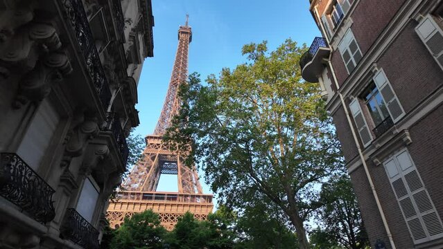 Image of Paris and the Eiffel Tower between buildings, unique point of view, city architecture. Capital of the 2024 Olympics. Paris 2024 Olympic Games.