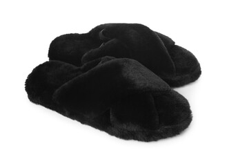 Pair of black fluffy slippers isolated on white