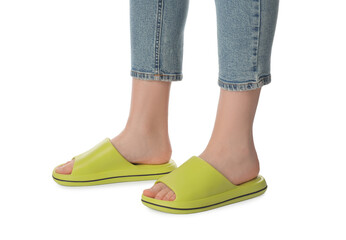 Woman in green slippers on white background, closeup