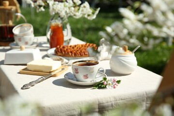 Beautiful table setting in spring garden on sunny day