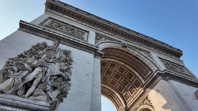 Point of view of Paris, France, showcases the Arc de Triomphe at sunset. The Champs-&Eacute;lys&eacute;es quarter, bustling with traffic and city life, epitomizes French culture and patriotism.