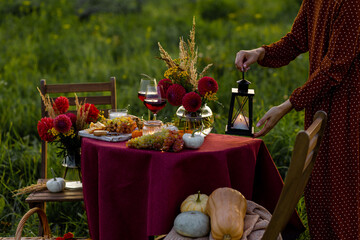 Beautiful elegant outdoor romantic dinner table decor countryside style: pumpkins, candles,...