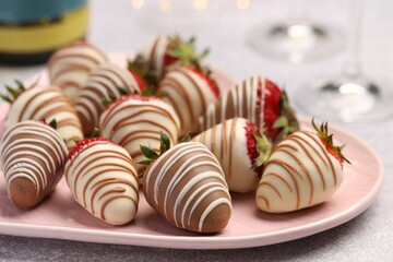 Delicious chocolate covered strawberries on light table, closeup