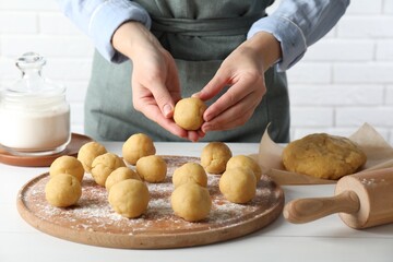 Shortcrust pastry. Woman making dough ball at white wooden table, closeup