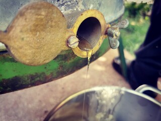 Honey extraction. Honey flows into a bucket while it is being harvested