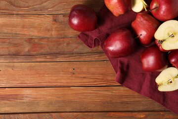 Fresh ripe red apples on wooden table, flat lay. Space for text